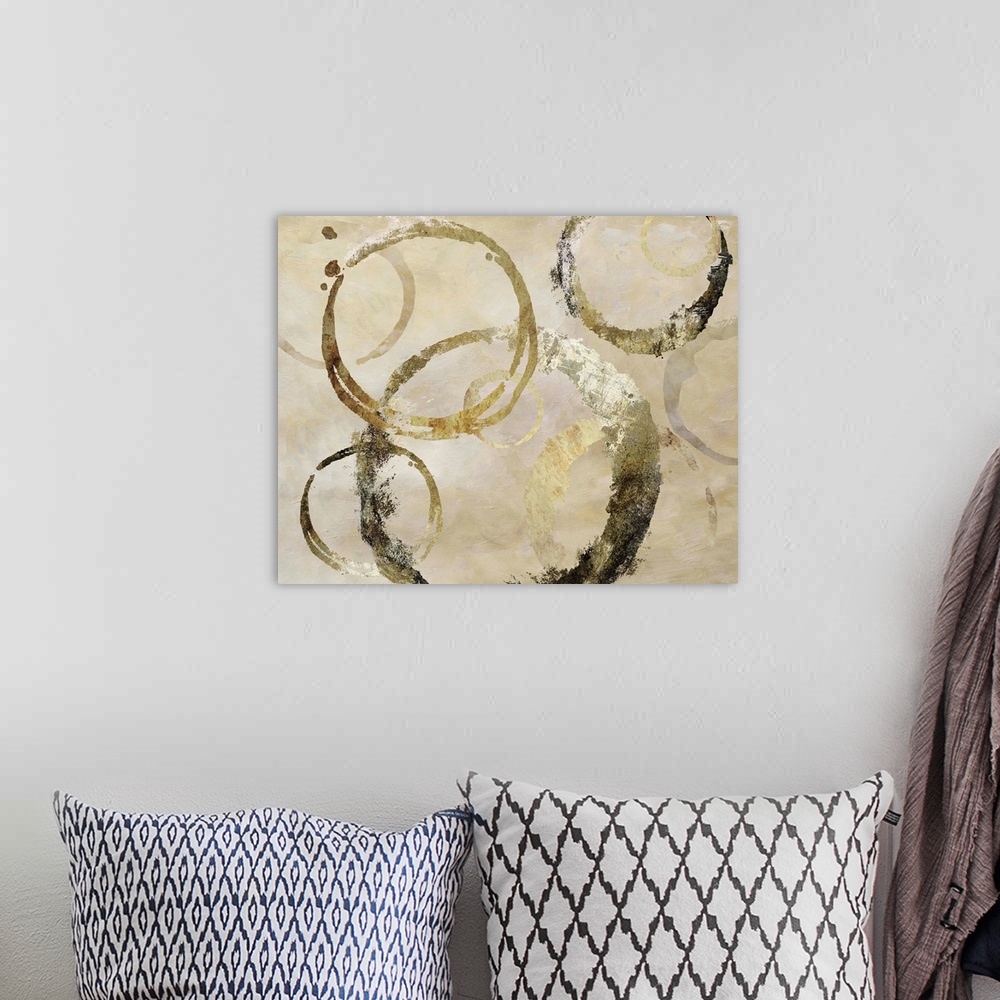 A bohemian room featuring Geometric abstract painting with distressed golden, dark gray and beige rings against a neutral t...