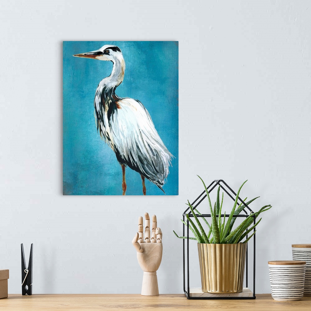 A bohemian room featuring Contemporary painting of a blue heron on a blue background.