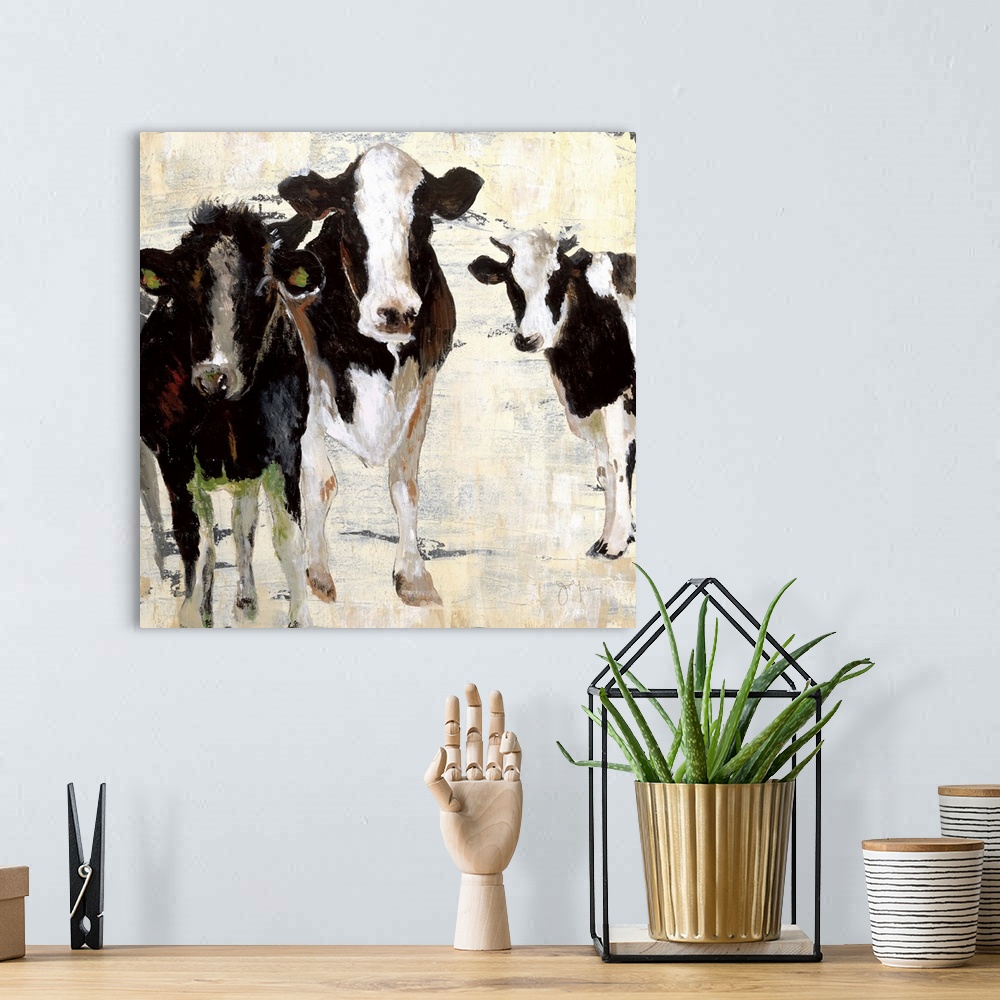 A bohemian room featuring A contemporary painting of three cows standing together using all natural colors with hints of gr...