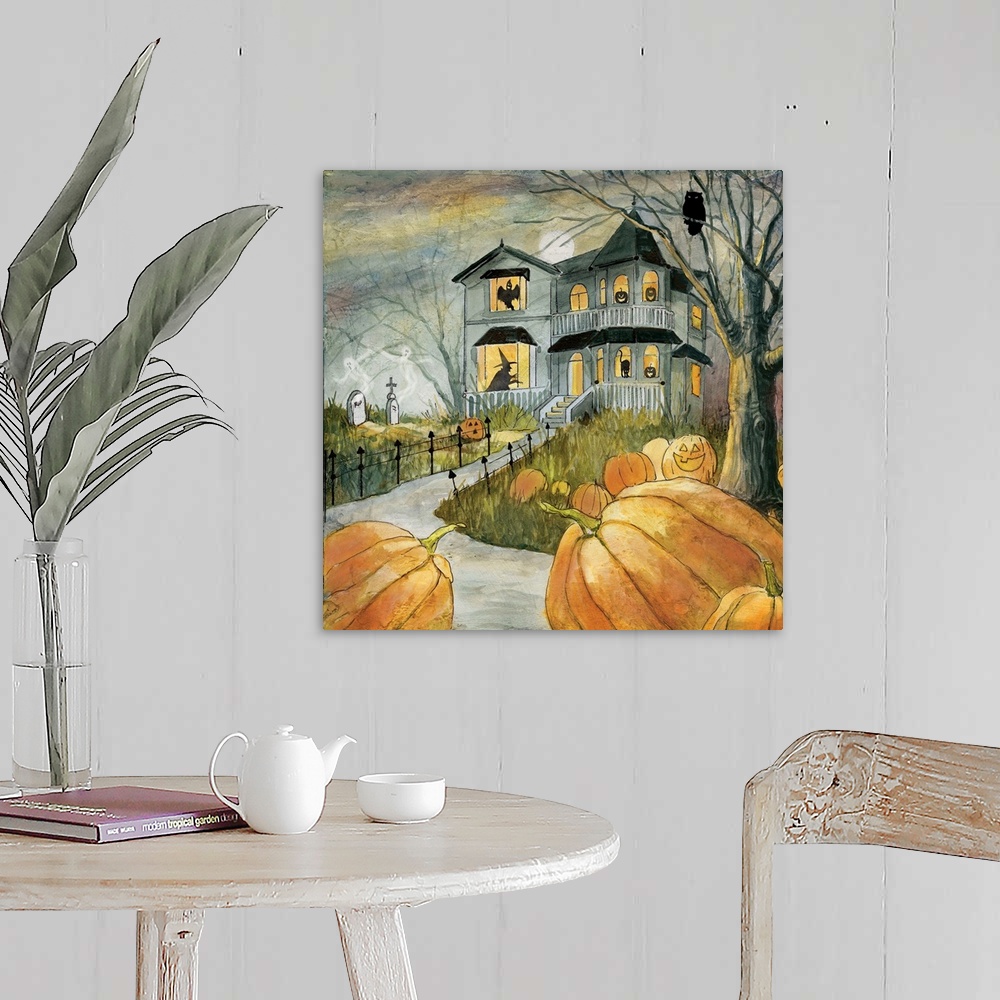 A farmhouse room featuring A spooky haunted house with figures in the windows surrounded by pumpkins.