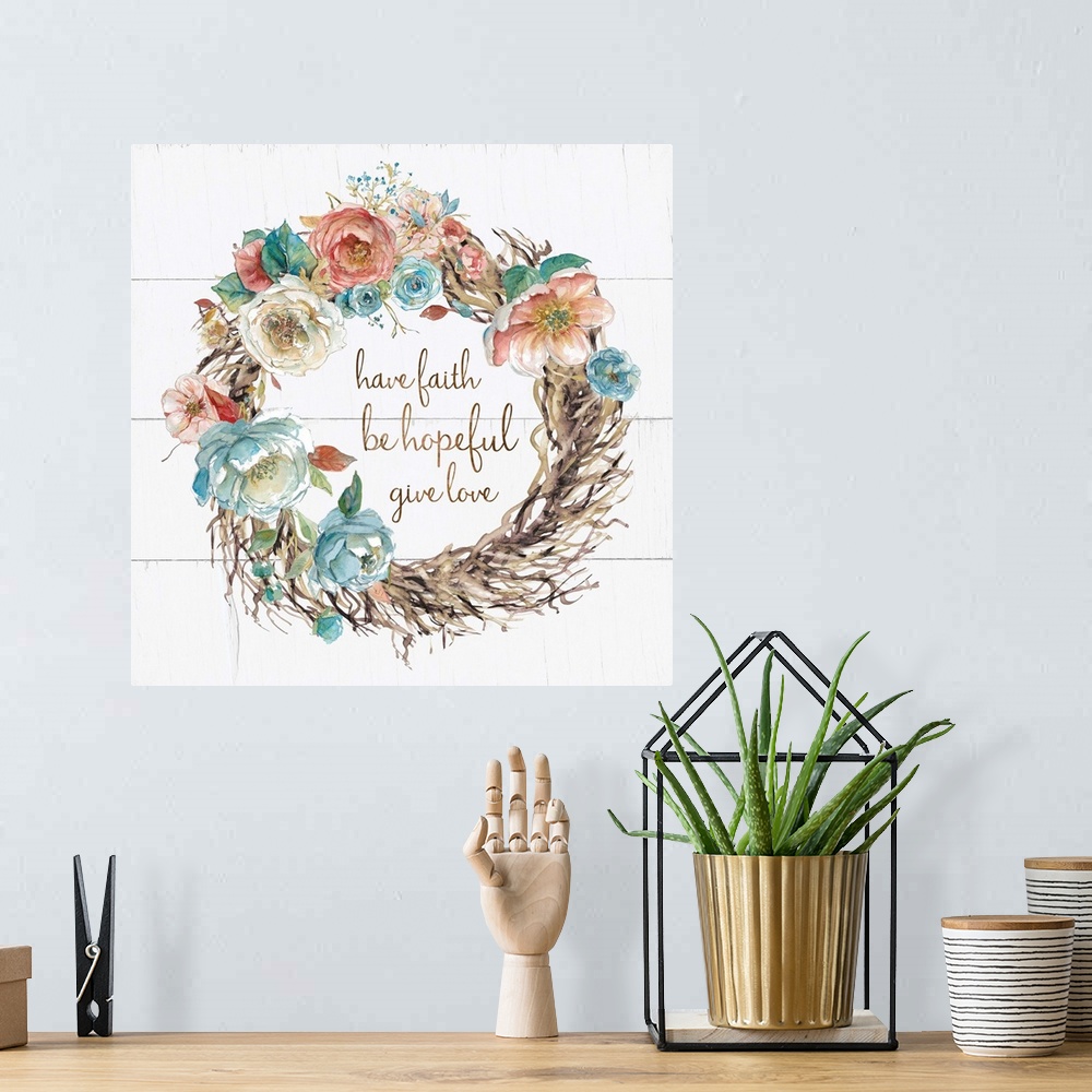 A bohemian room featuring A wreath of watercolor flowers and branches surround the hand lettering sentiment, "Have faith, b...