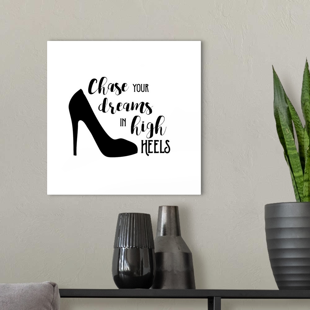 A modern room featuring Decorative artwork with the text "Chase Your Dreams in High Heels" with a shoe.