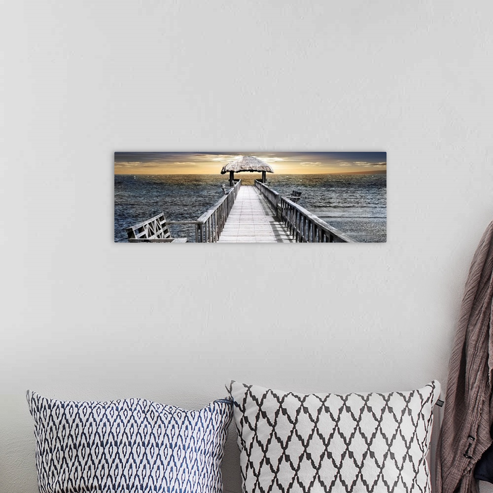 A bohemian room featuring Panoramic photo of a pier reaching out to the sea with a thatched roof near the horizon.