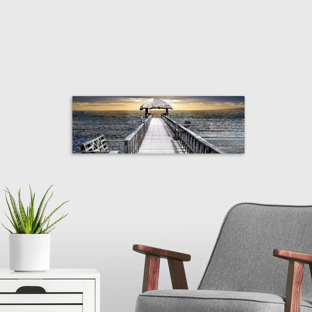 A modern room featuring Panoramic photo of a pier reaching out to the sea with a thatched roof near the horizon.