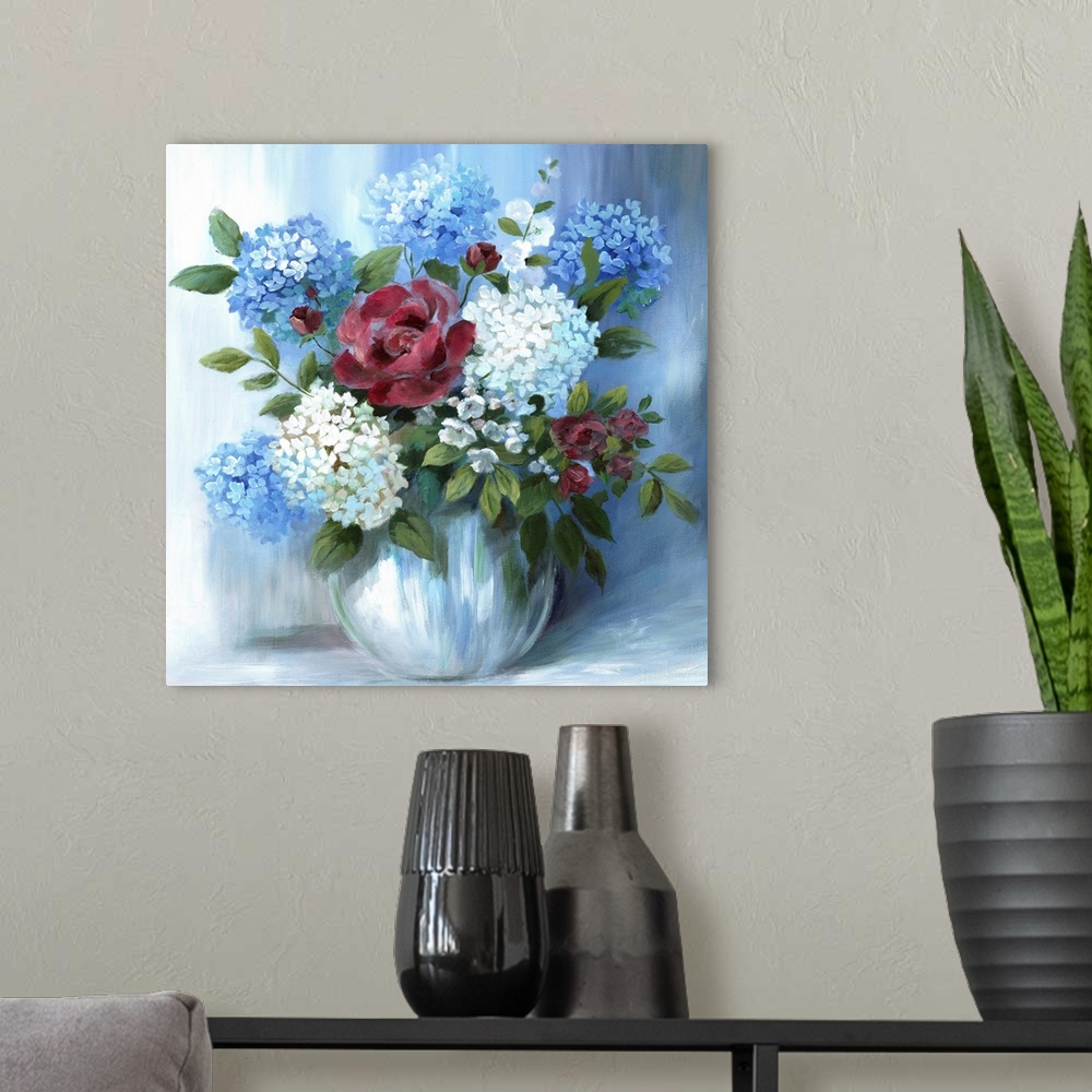 A modern room featuring Square still life painting of a floral arrangement with blue tones.
