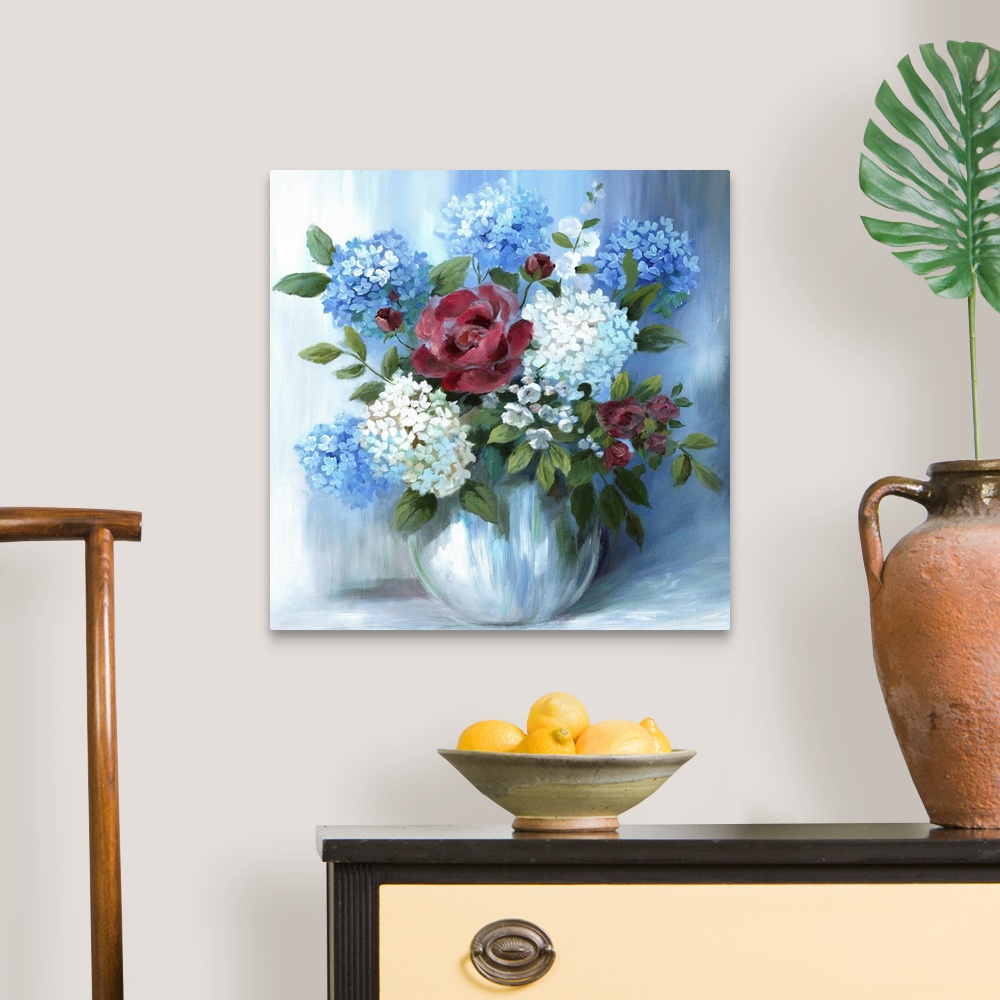 A traditional room featuring Square still life painting of a floral arrangement with blue tones.