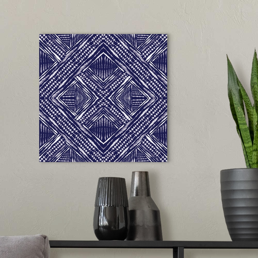 A modern room featuring Square abstract art in indigo and white hues with kaleidoscope-like patterns and designs.