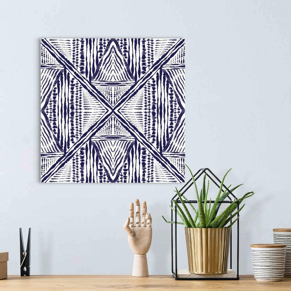 A bohemian room featuring Square abstract art in indigo and white hues with kaleidoscope-like patterns and designs.