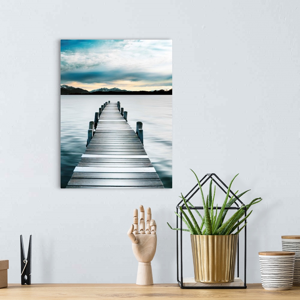 A bohemian room featuring Photograph of a wooden boardwalk on a jetty with snow capped mountains in the distance.