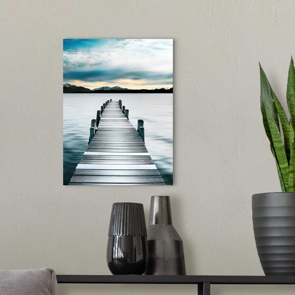A modern room featuring Photograph of a wooden boardwalk on a jetty with snow capped mountains in the distance.