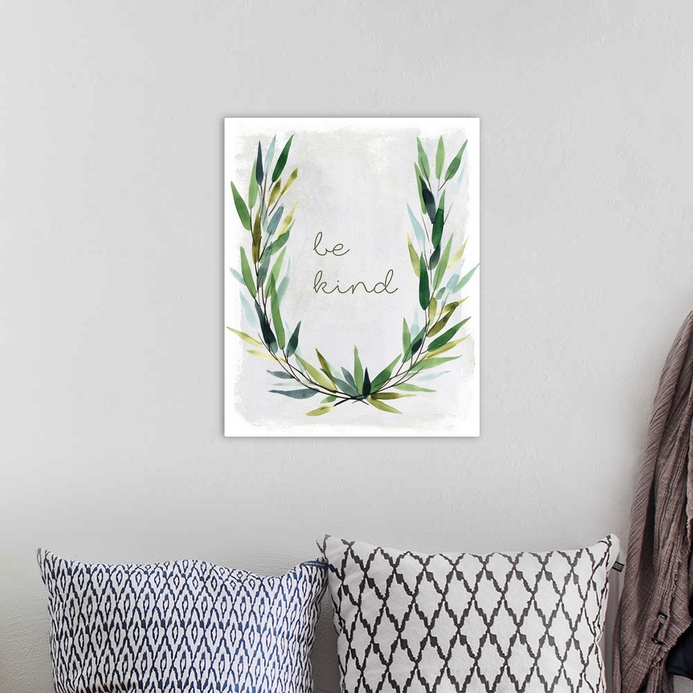 A bohemian room featuring "Be Kind" placed on a white textured background with leaves surrounding it.