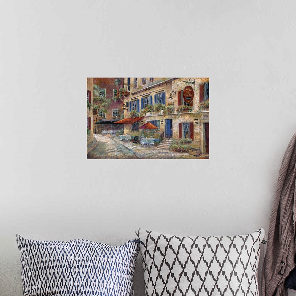 A bohemian room featuring Contemporary art print of the facade of street cafes in rural France.