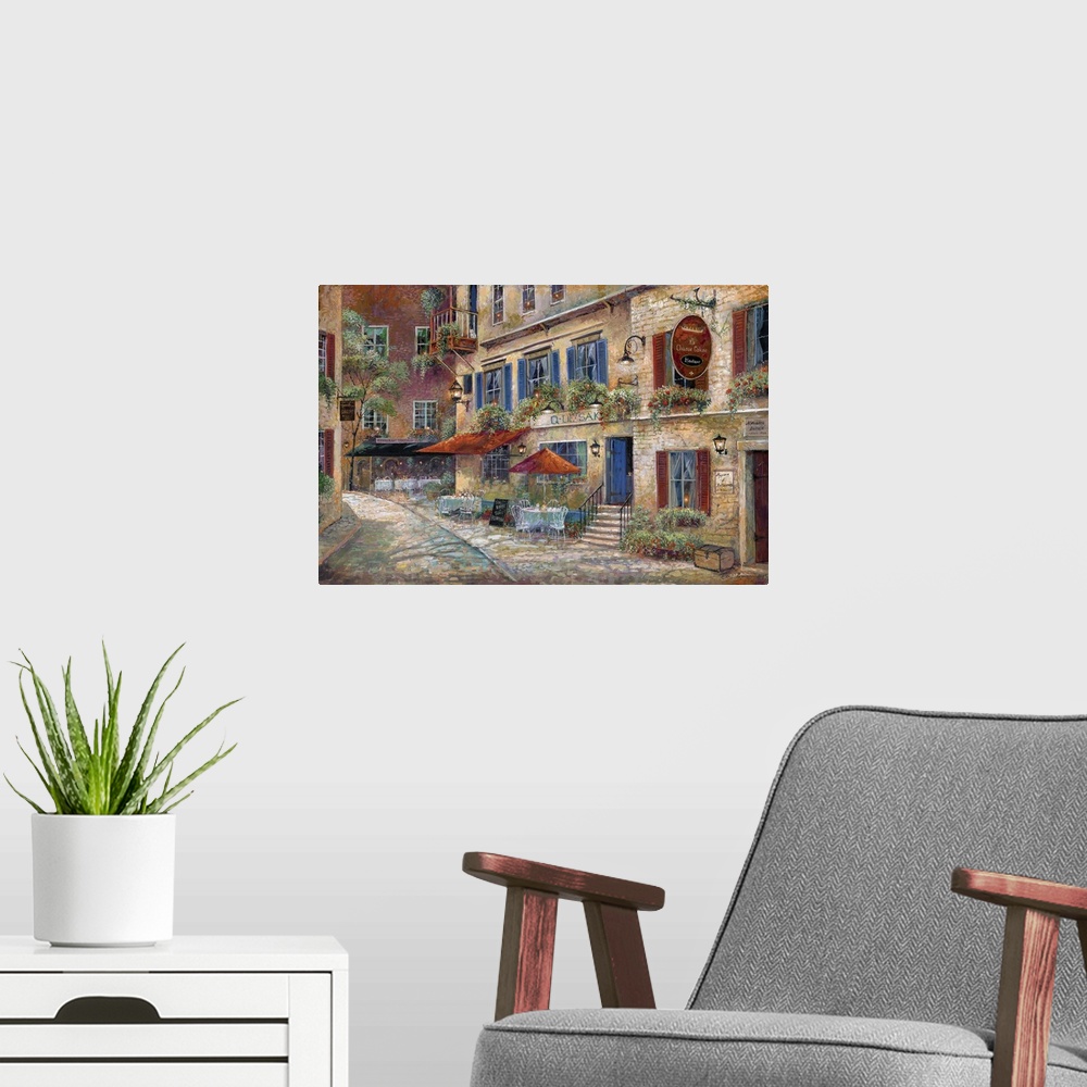 A modern room featuring Contemporary art print of the facade of street cafes in rural France.