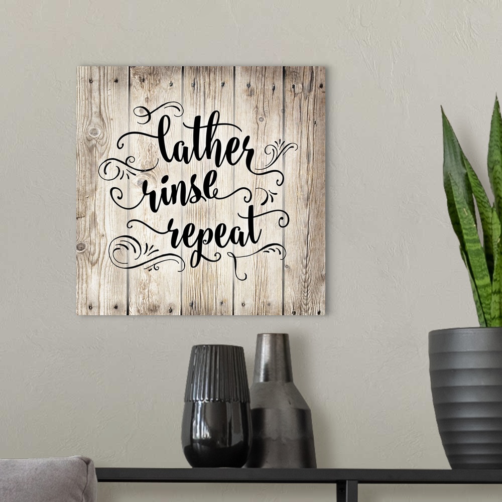 A modern room featuring The words "Lather, rinse, repeat" is arranged on this square light wood design with decorated emb...