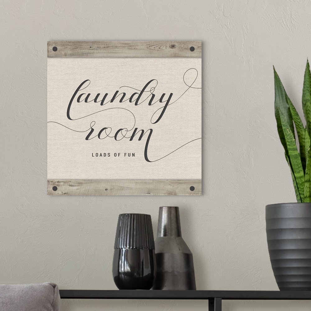 A modern room featuring Laundry Room 'Loads of Fun' neutral colored square sign.