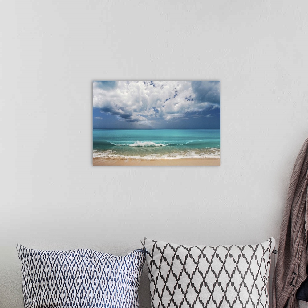 A bohemian room featuring Landscape photograph of the ocean's crashing waves onto the shore on a beautiful day.