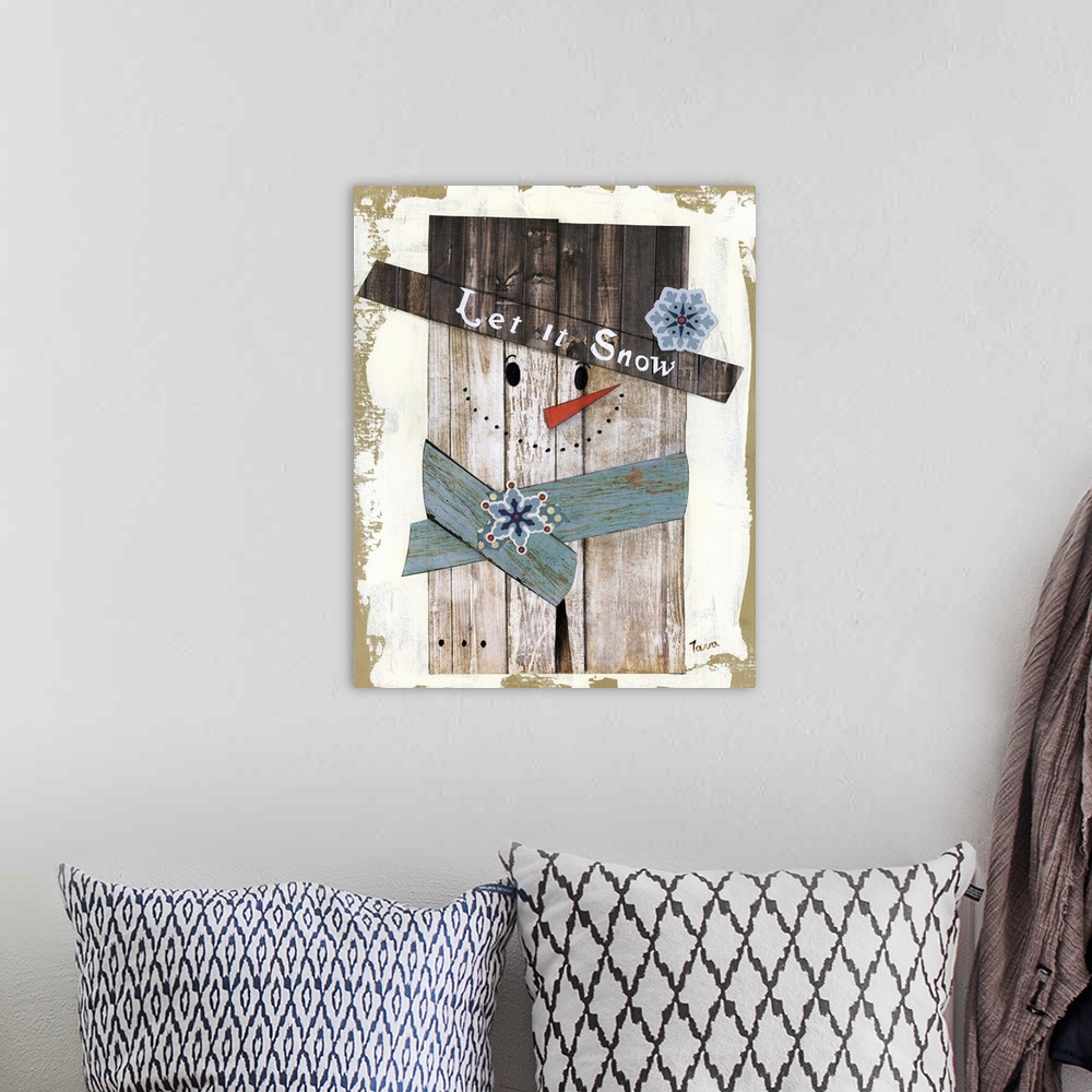 A bohemian room featuring A decorative winter painting of a snowman made out of wood that says ?Let it Snow? on its top hat.
