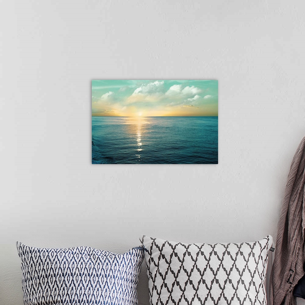 A bohemian room featuring A photo of a solace sunrise glimmering on the ocean as it ascends to the sky.