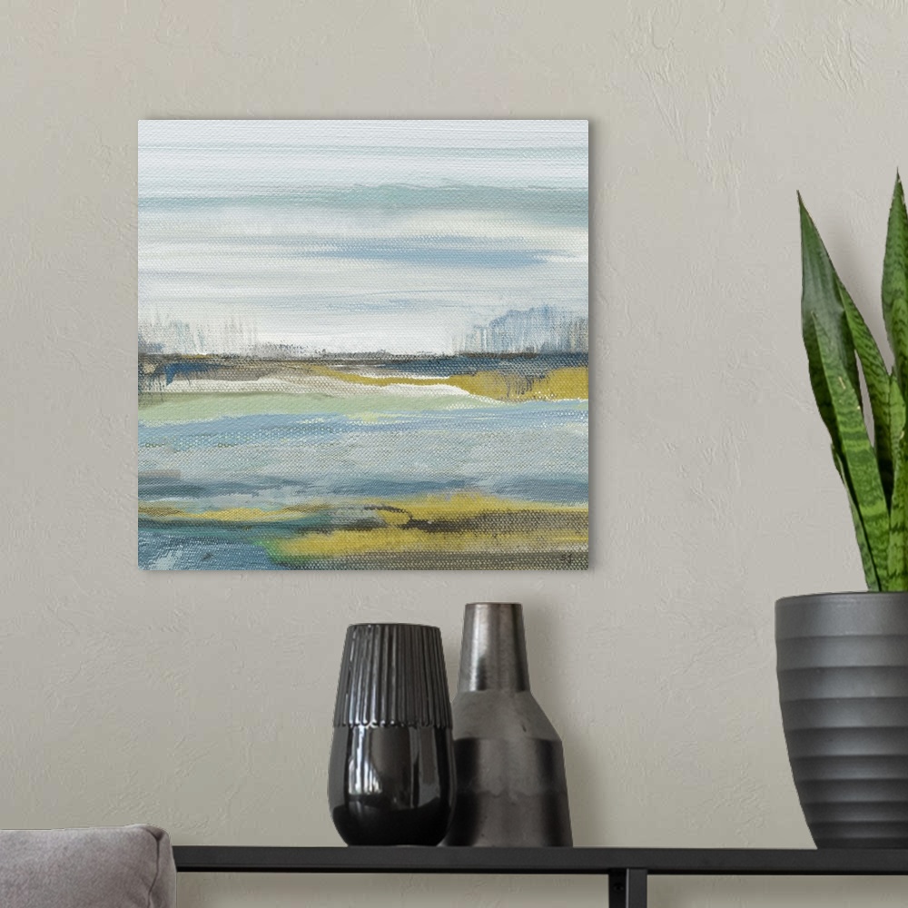 A modern room featuring Square painting of an abstract beach landscape in shades of blue, green, grey, and gold.