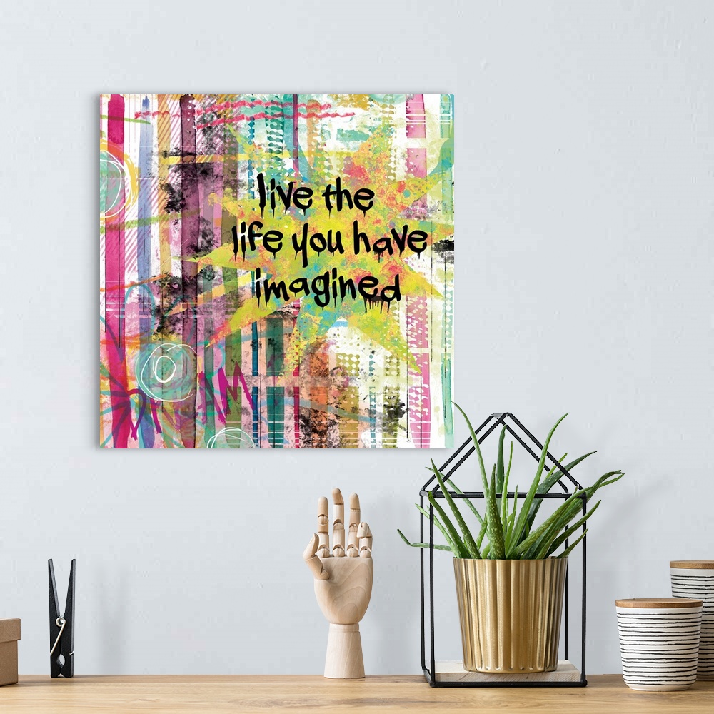 A bohemian room featuring Inspirational square painting with colorful lines and designs and the phrases "Live the Life You ...