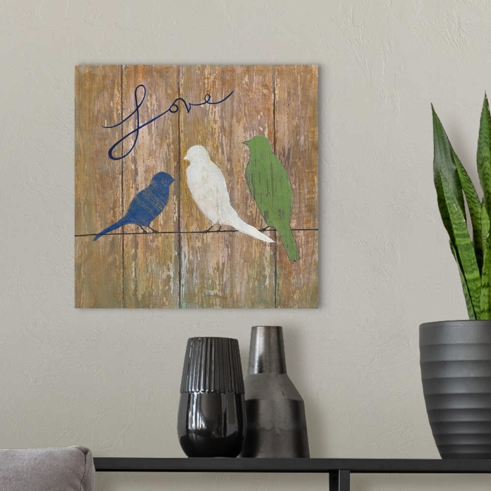 A modern room featuring A painting of three birds sitting on a line with the word ?Love? painted at the top on a wooden b...