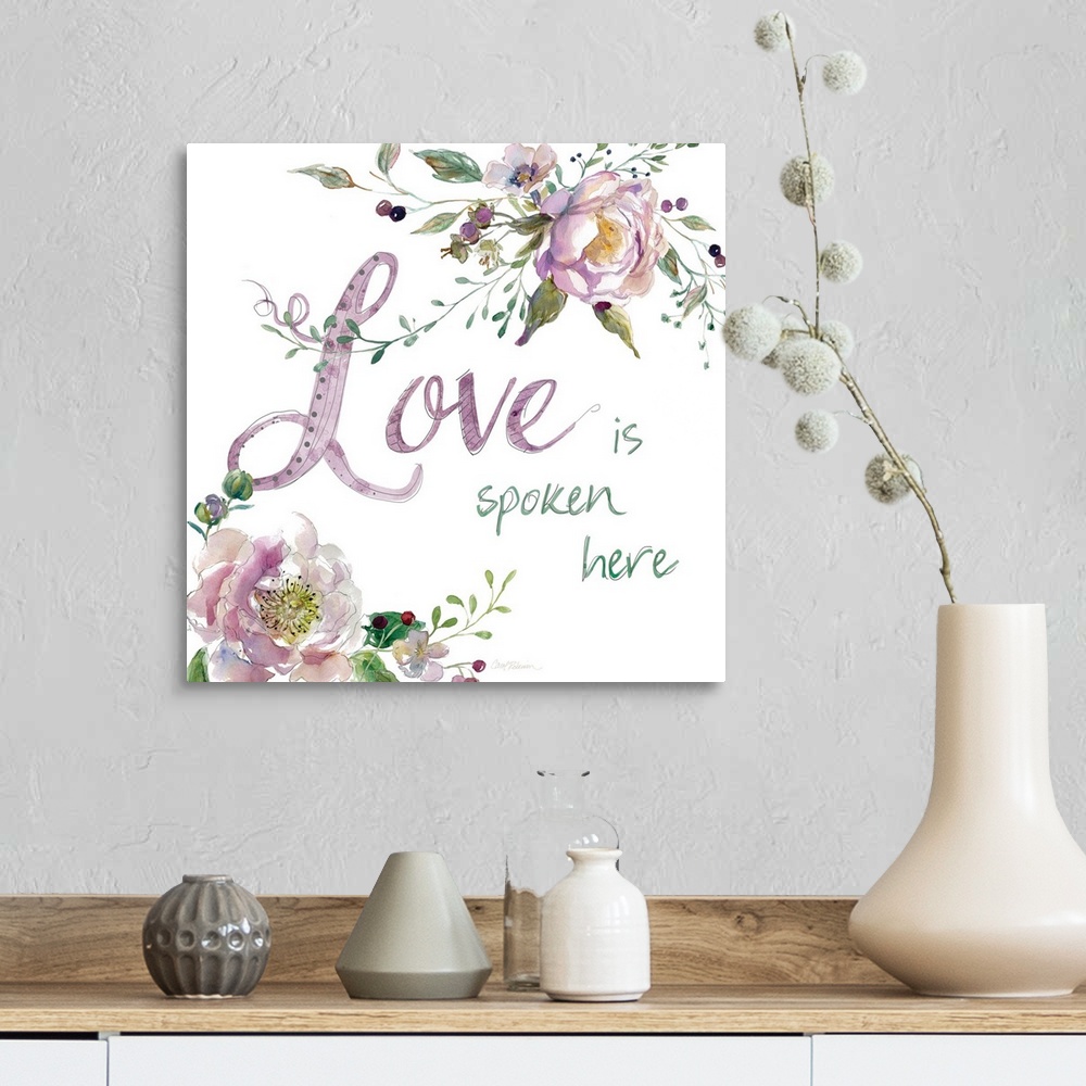 A farmhouse room featuring "Love is Spoken Here" with water color flowers.