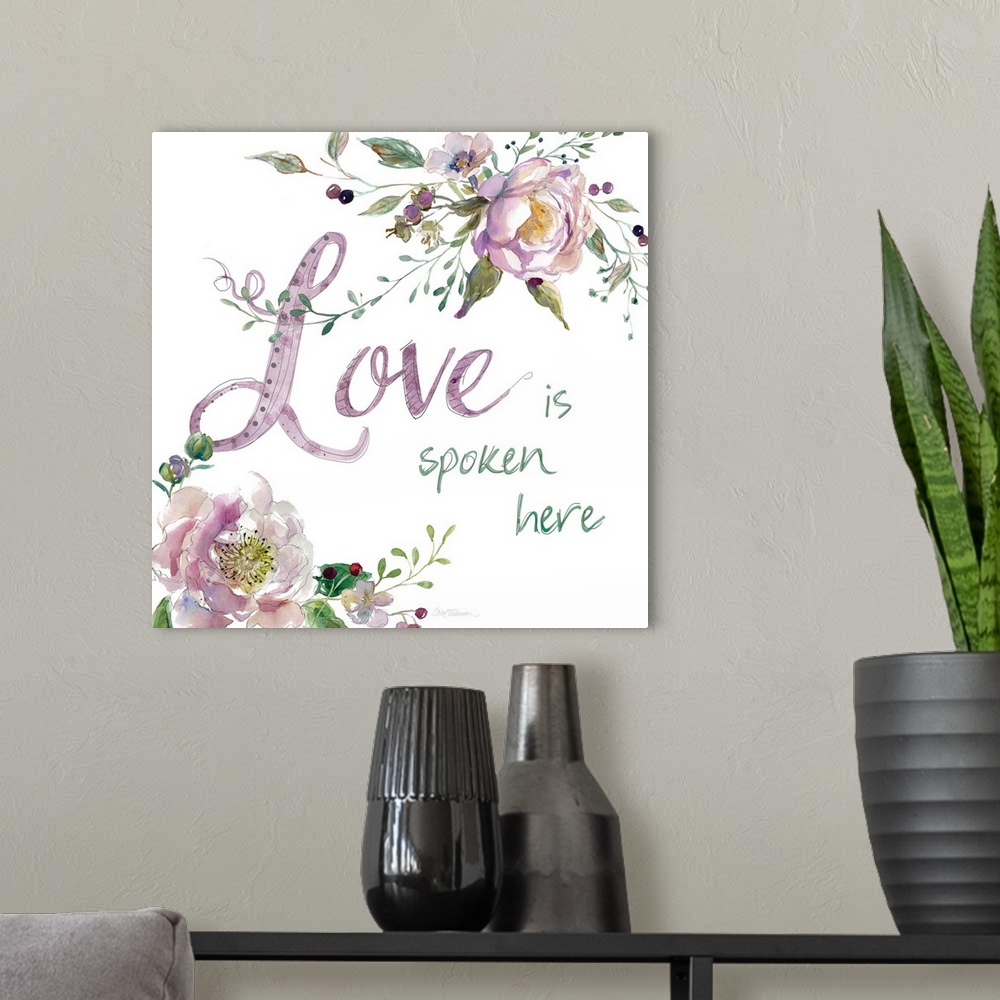 A modern room featuring "Love is Spoken Here" with water color flowers.