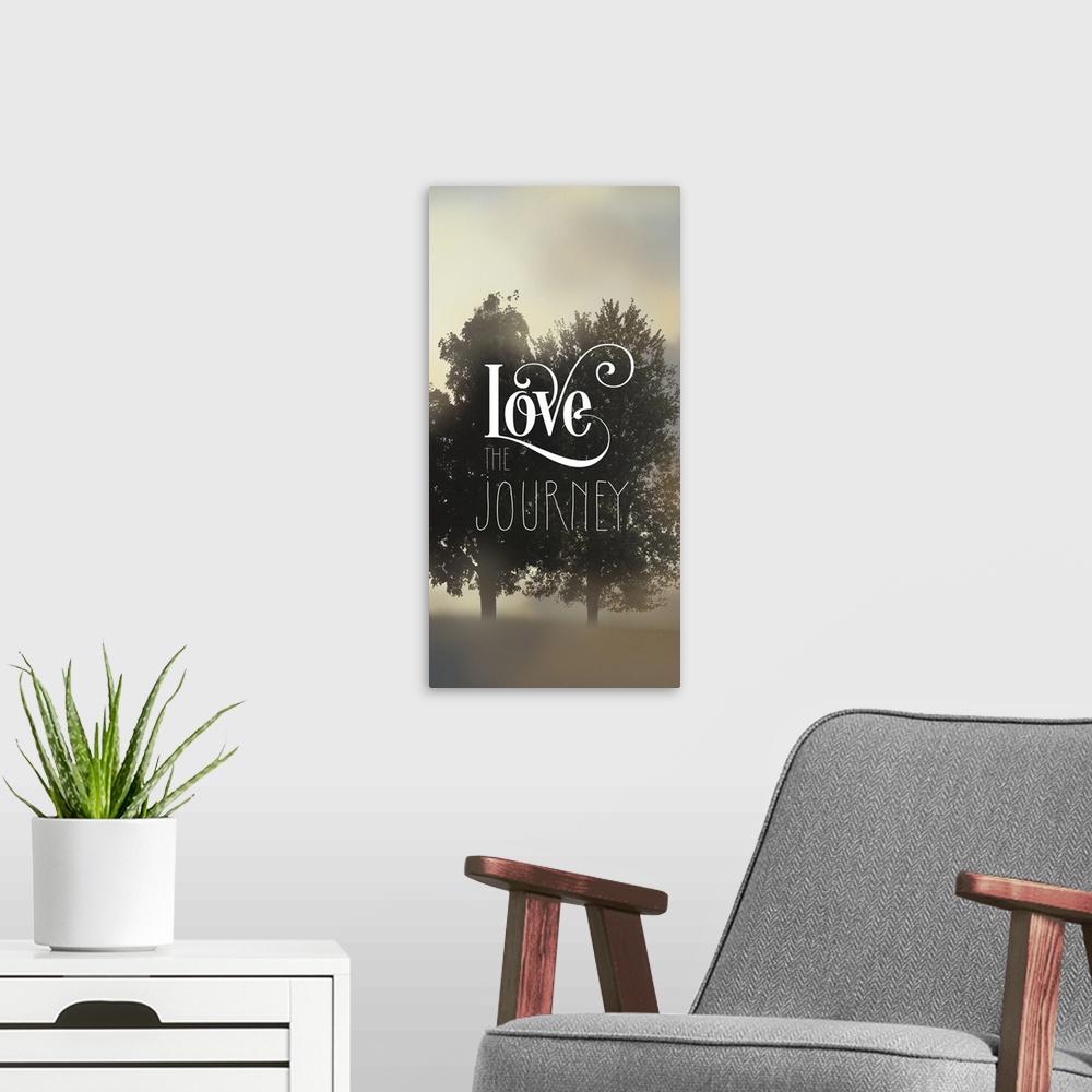 A modern room featuring "Love The Journey" written on top of a silhouette of two trees amongst fog.