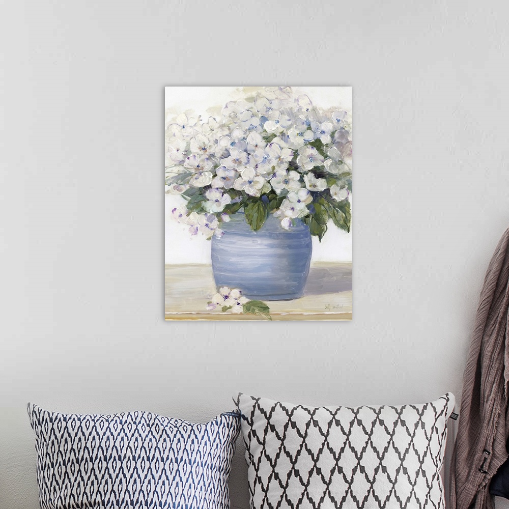 A bohemian room featuring Large still life painting of arranged hydrangeas on a table.