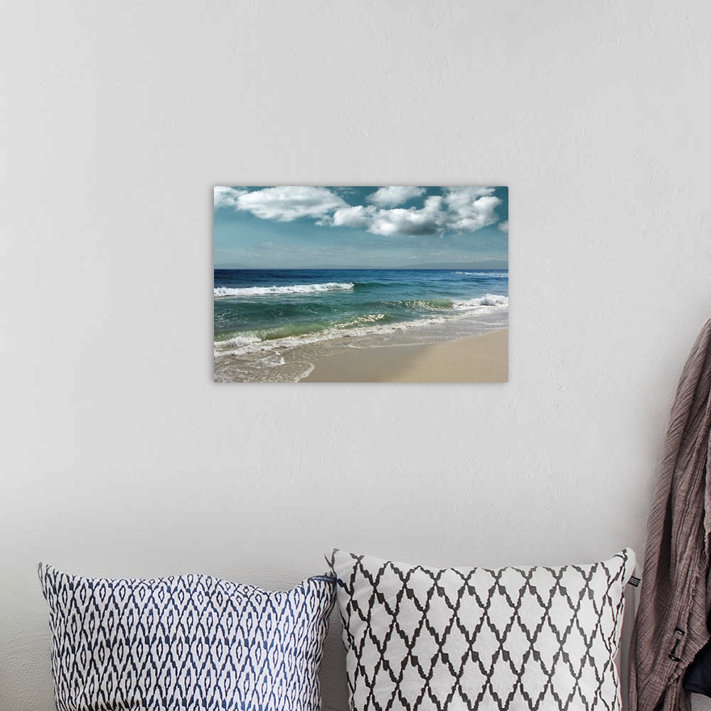 A bohemian room featuring This serene photo shows rippling waves as they approach the beach with puffy white clouds in the ...