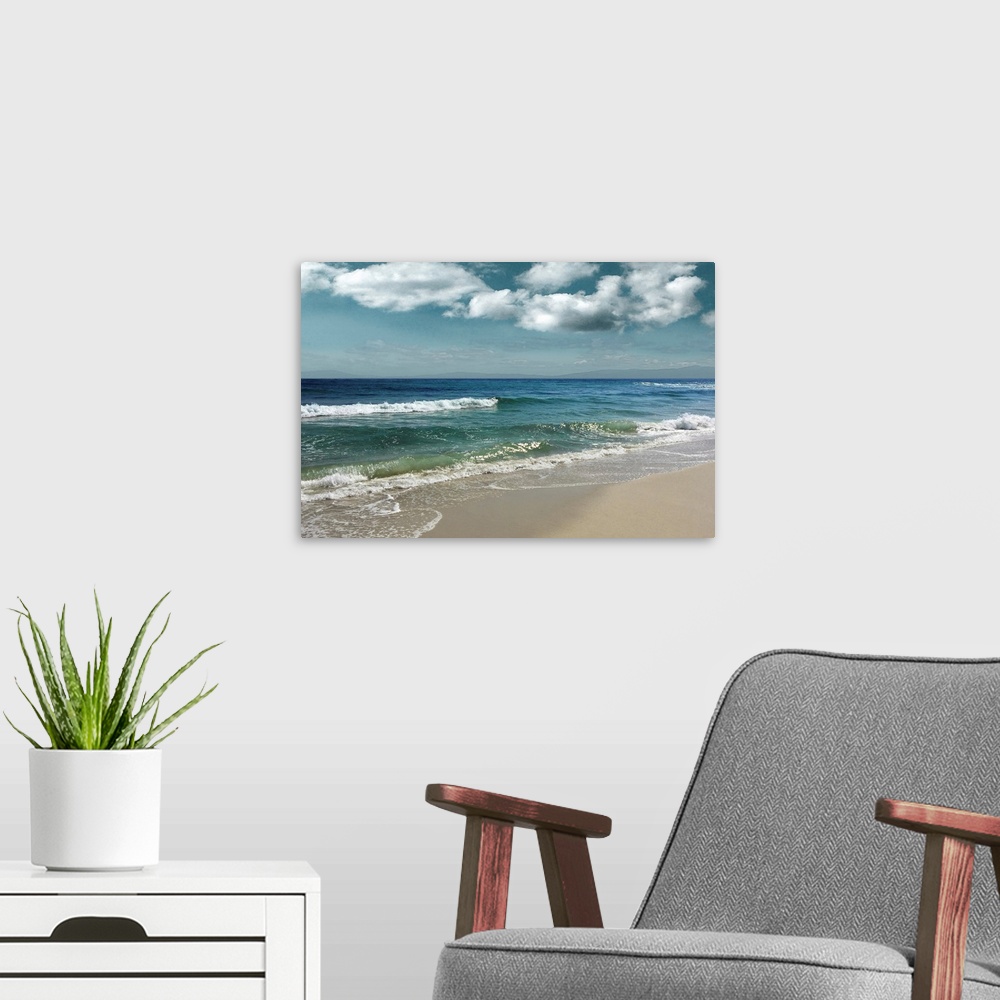 A modern room featuring This serene photo shows rippling waves as they approach the beach with puffy white clouds in the ...