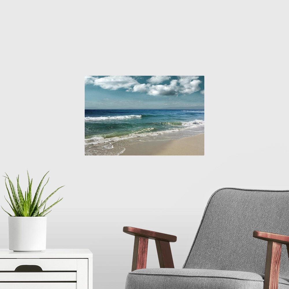 A modern room featuring This serene photo shows rippling waves as they approach the beach with puffy white clouds in the ...
