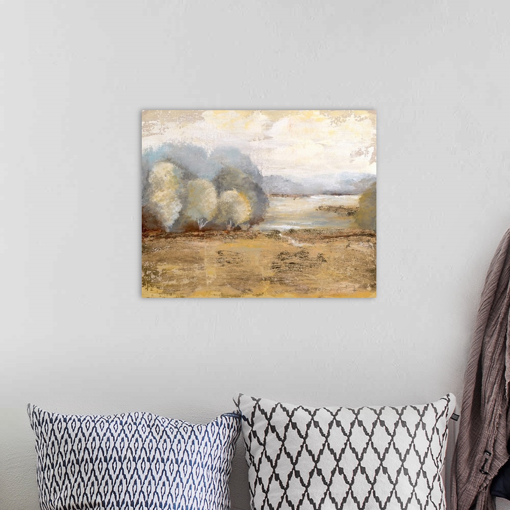 A bohemian room featuring Contemporary landscape painting of a golden field with soft trees at the edge and a pale yellow sky.