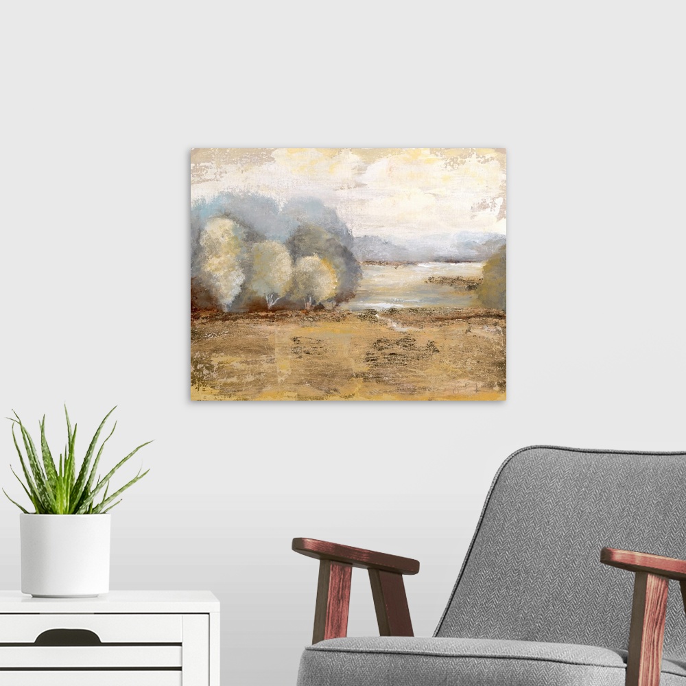 A modern room featuring Contemporary landscape painting of a golden field with soft trees at the edge and a pale yellow sky.