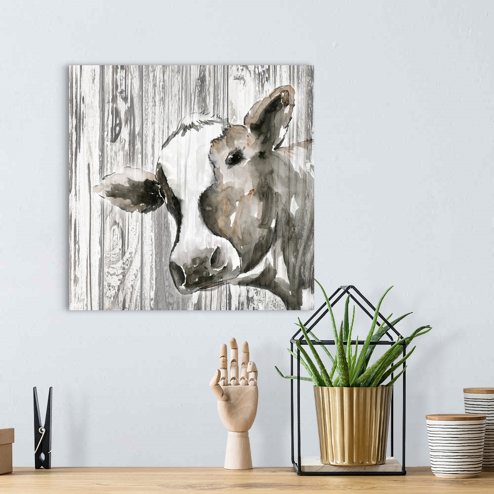 A bohemian room featuring Decorative artwork of a cow with a rustic wood backdrop.