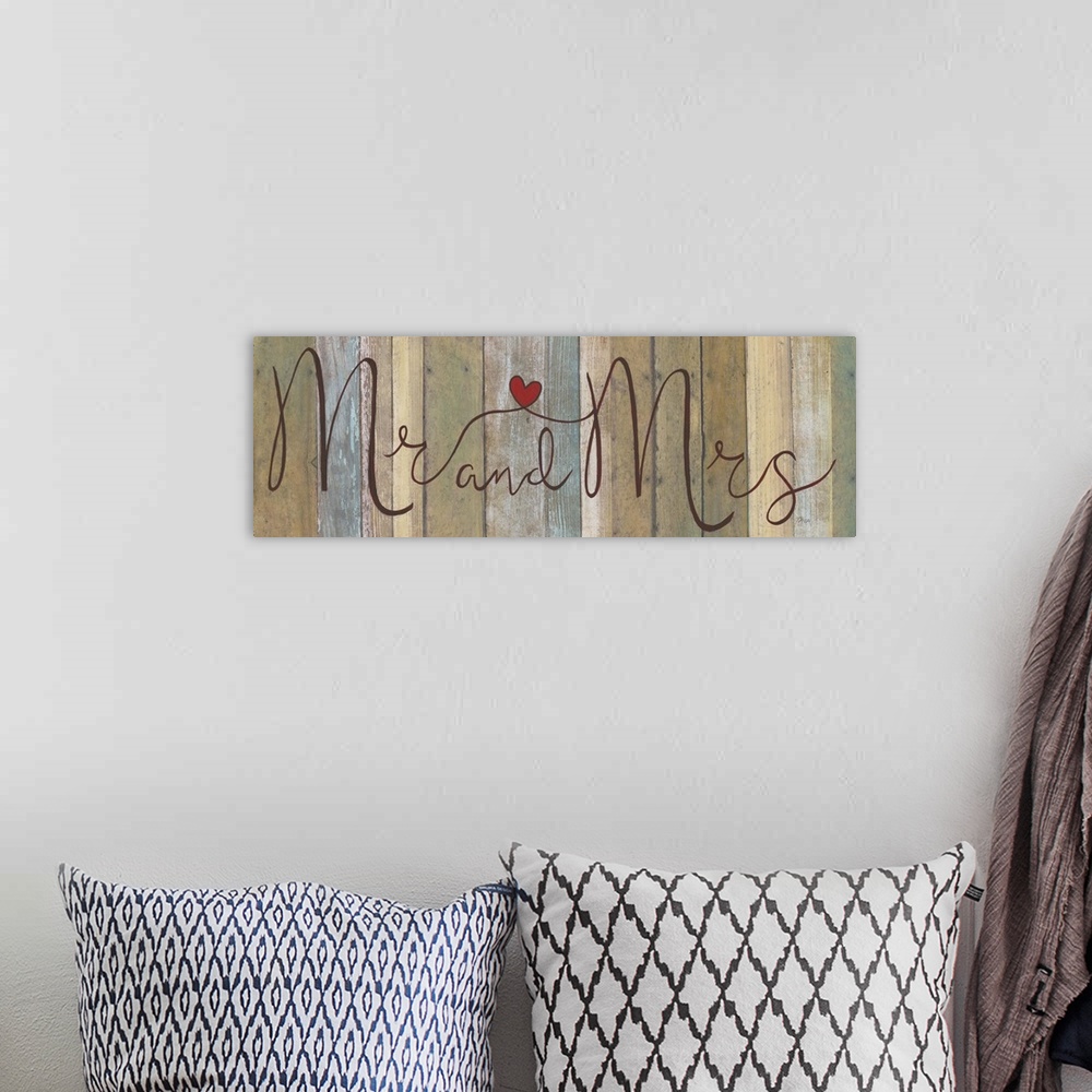 A bohemian room featuring ?Mr and Mrs? painted in cursive on a multicolored wood background with a red heart connecting in ...