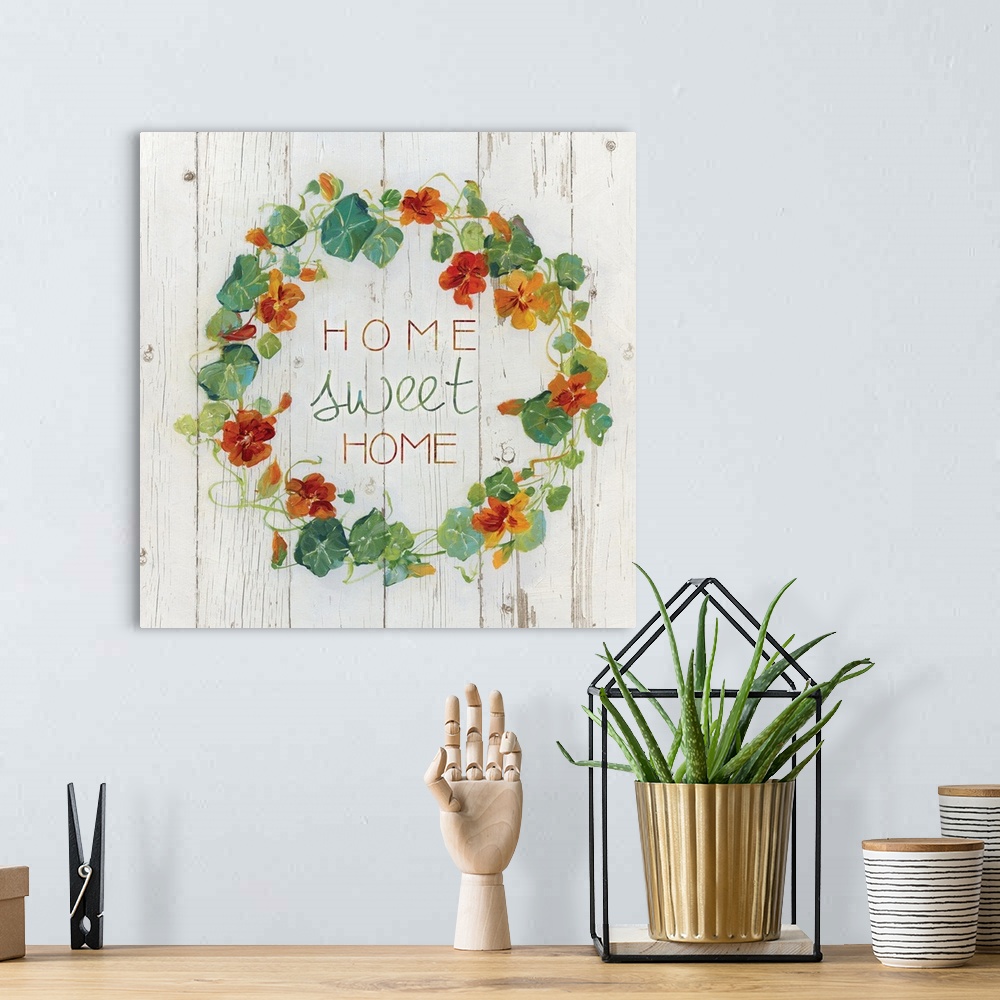 A bohemian room featuring "Home, sweet home" quote is framed with a wreath of Nasturtium flowers.