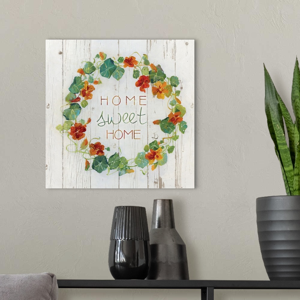 A modern room featuring "Home, sweet home" quote is framed with a wreath of Nasturtium flowers.