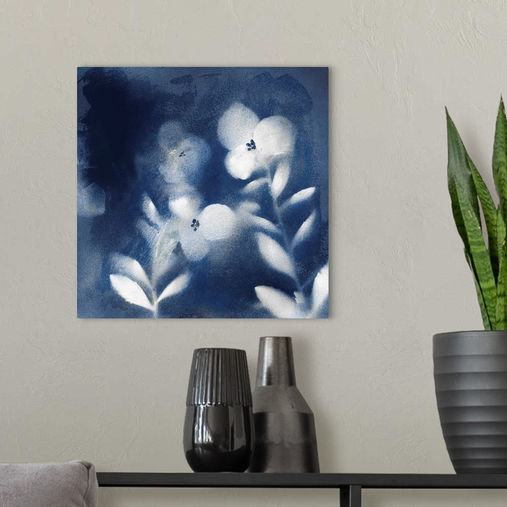 A modern room featuring Square indigo painting of white silhouettes of flowers.