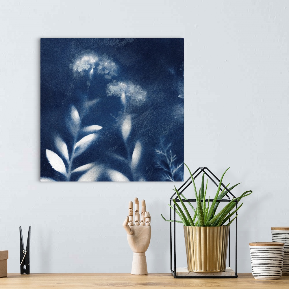 A bohemian room featuring Square indigo painting of white silhouettes of flowers.