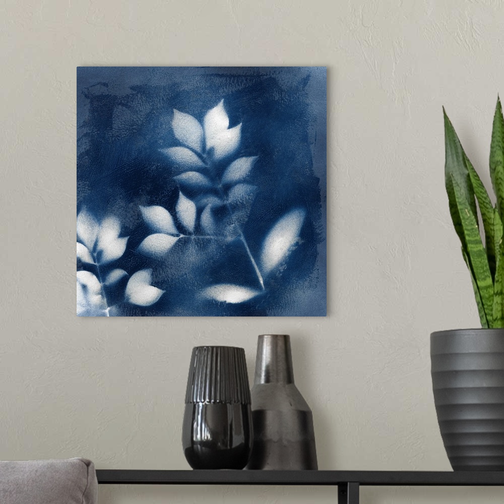 A modern room featuring Square indigo painting of white silhouettes of leaves.