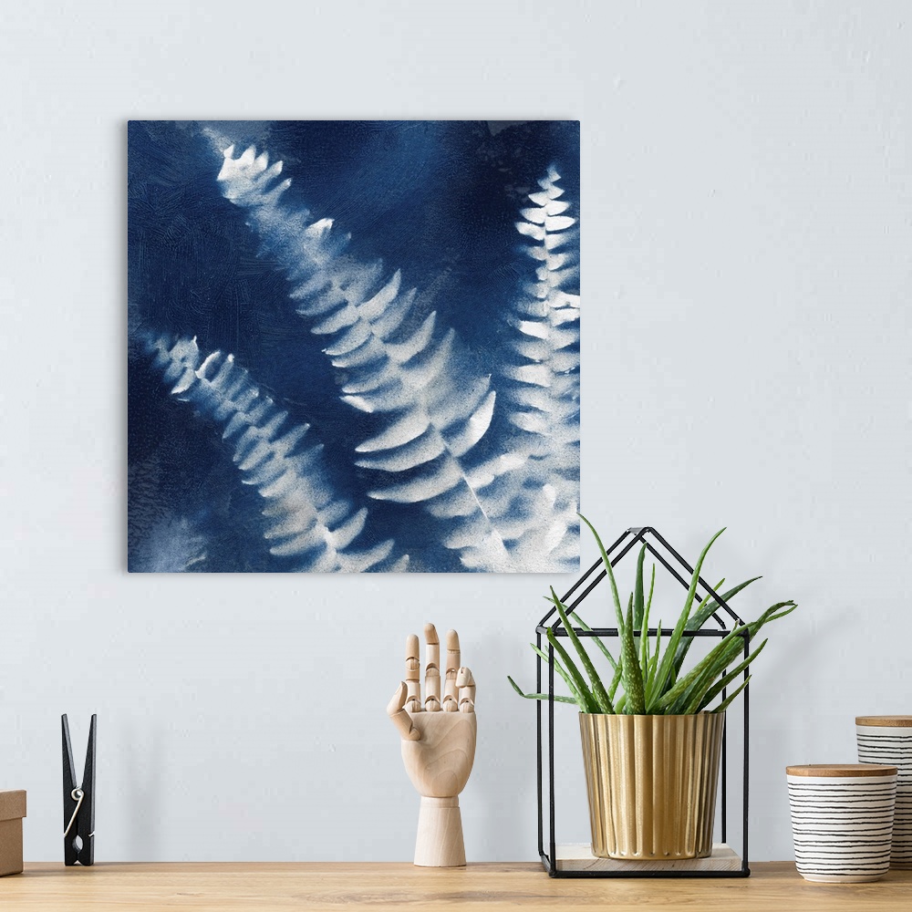 A bohemian room featuring Square indigo painting of white silhouettes of fern leaves.