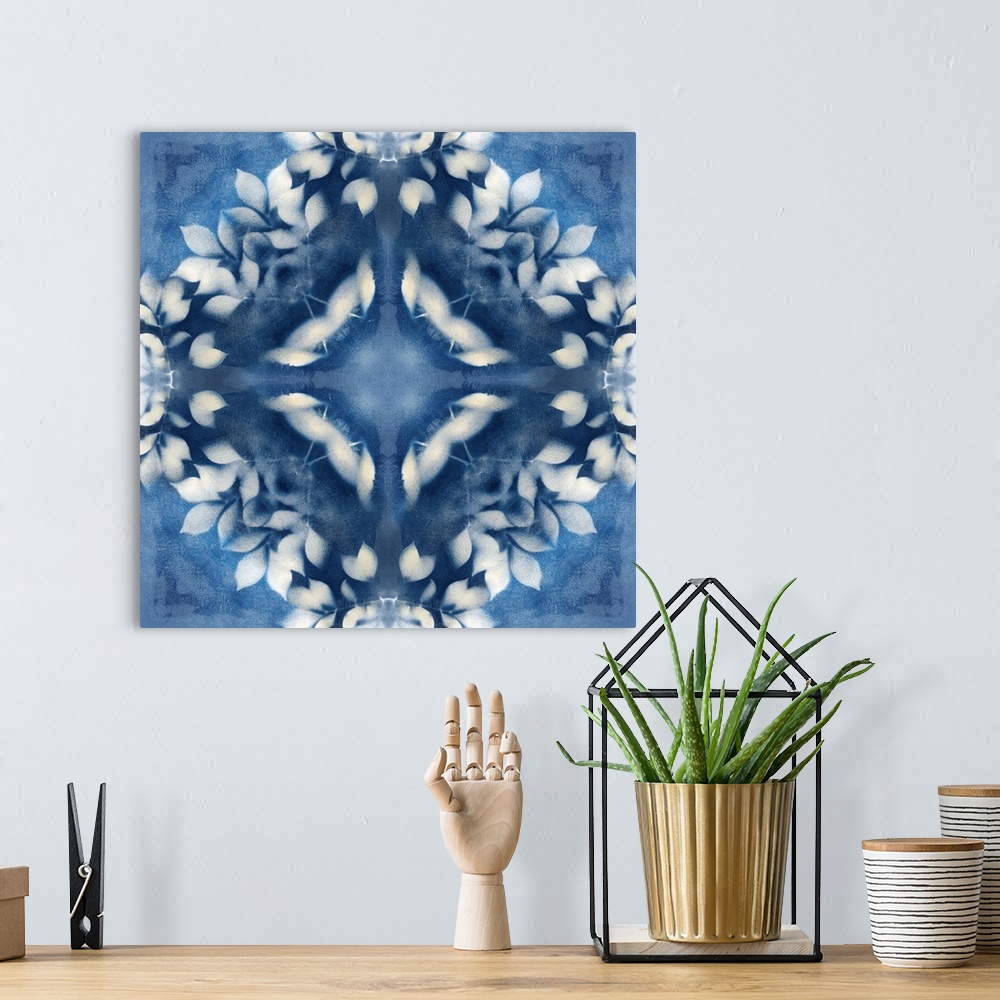 A bohemian room featuring Square abstract art in navy blue and white hues with kaleidoscope-like patterns and designs.