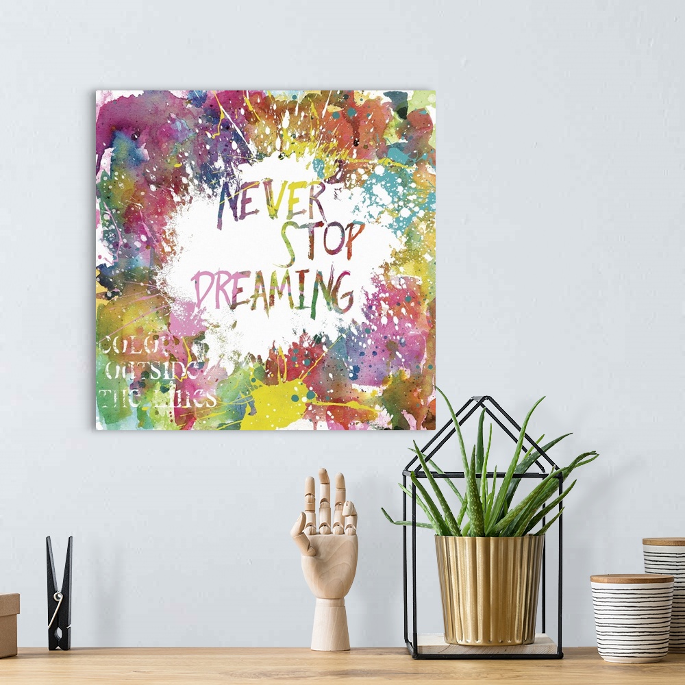 A bohemian room featuring Inspirational square painting with colorful paint splatter and the phrases "Never Stop Dreaming" ...