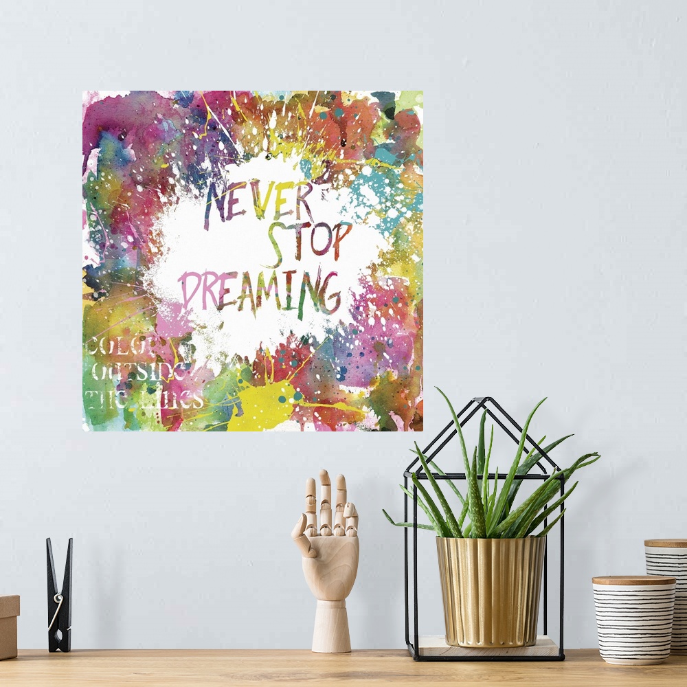A bohemian room featuring Inspirational square painting with colorful paint splatter and the phrases "Never Stop Dreaming" ...
