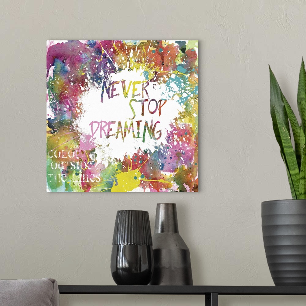 A modern room featuring Inspirational square painting with colorful paint splatter and the phrases "Never Stop Dreaming" ...