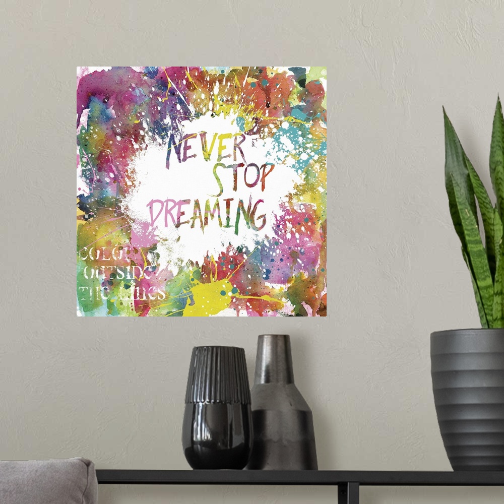 A modern room featuring Inspirational square painting with colorful paint splatter and the phrases "Never Stop Dreaming" ...