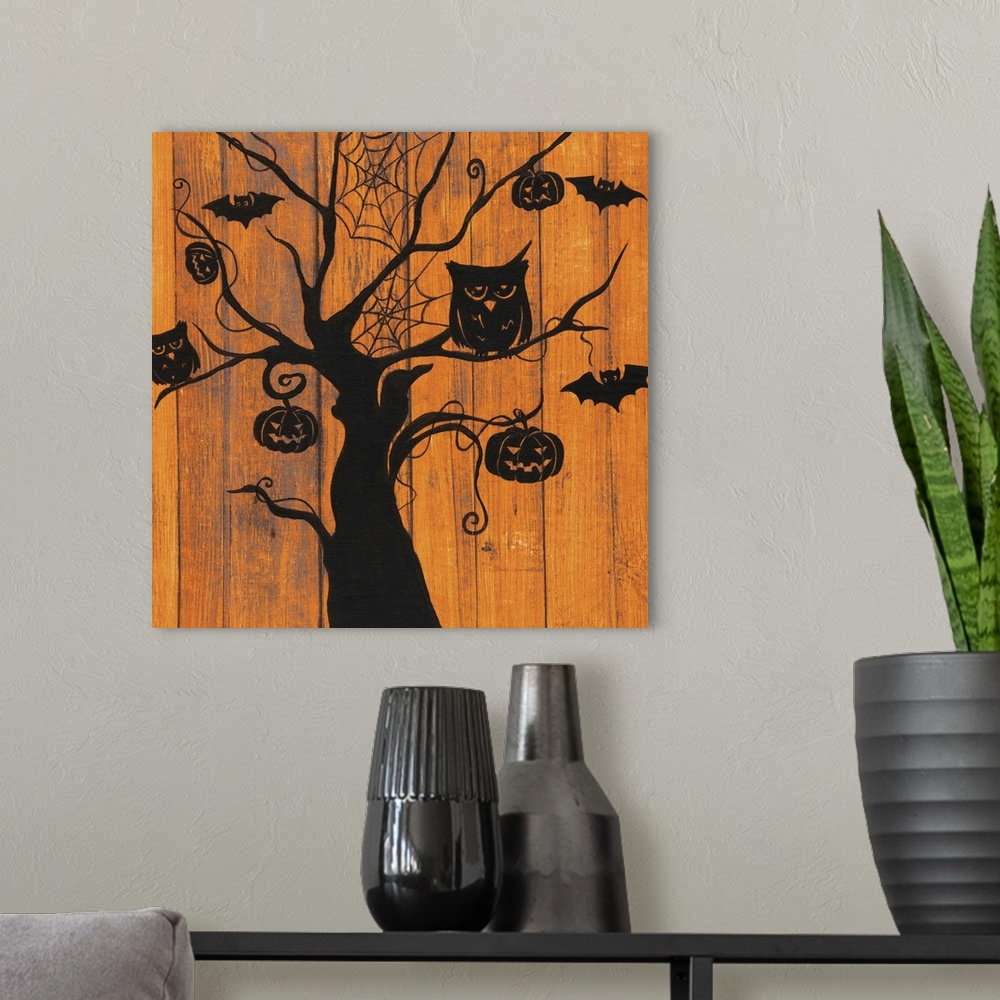 A modern room featuring A decorative Halloween painting of a spooky tree with owls, bats, jack o lanterns, and spider web...