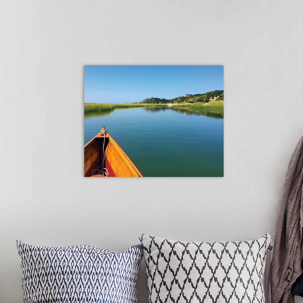A bohemian room featuring Photograph of the front of a boat floating down an inlet towards the shore.