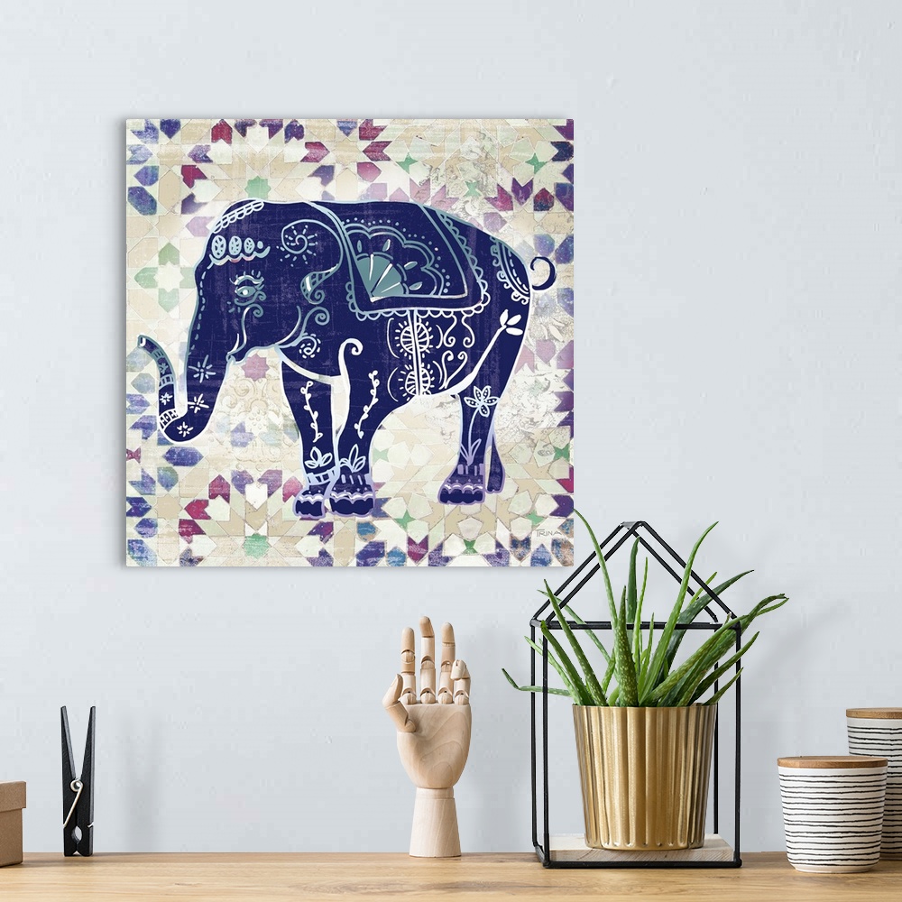 A bohemian room featuring Square decor with an indigo elephant that has beautiful designs on top of a patterned background.